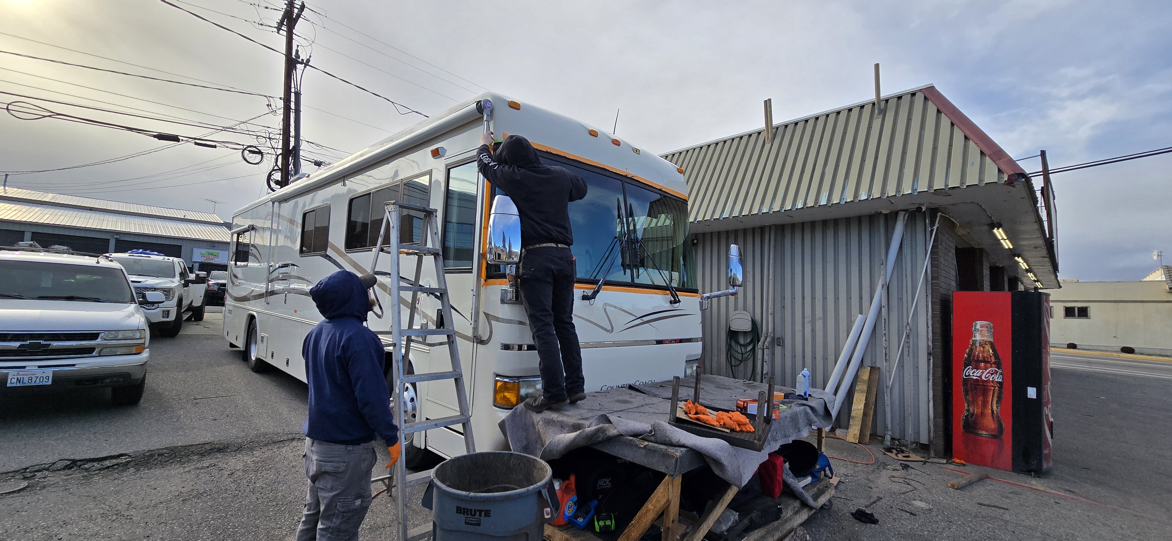 Millenium technicians replacing a motorhome windshield